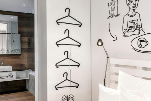 a bedroom with hangers on the wall at Pytloun Grand Hotel Imperial in Liberec