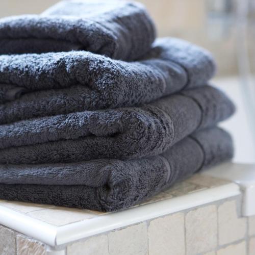 a pile of towels sitting on a shelf at Casa di Cocco in Alzano Lombardo