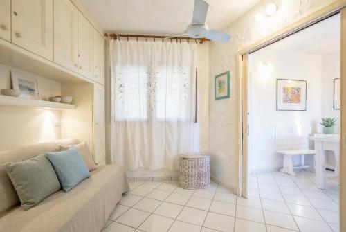 a living room with a couch and a window at Costa Corallina Villa with direct beach access and stunning views in Costa Corallina