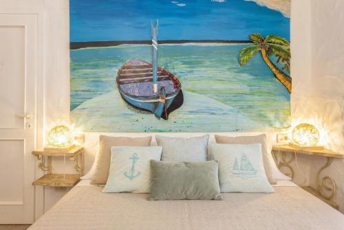a bedroom with a painting of a boat on the ocean at Costa Corallina Villa with direct beach access and stunning views in Costa Corallina