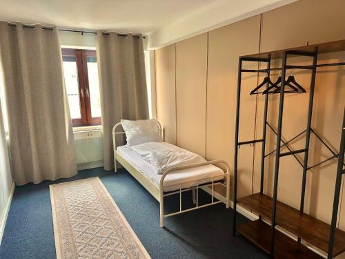 a room with a bed and a chair and a window at City Apartment Hamburg Work Relax Repeat in Hamburg
