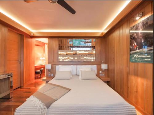 a large white bed in a room with a window at Villa Carla in Bonifacio