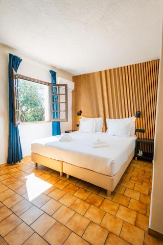 ein Schlafzimmer mit einem großen Bett und einem Fenster in der Unterkunft Casa do Alto in Vilamoura