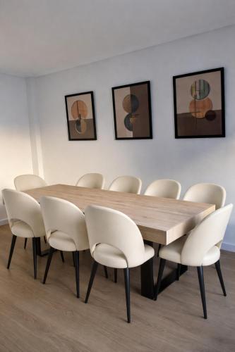 a dining room with a wooden table and chairs at Entre Plazas in Cáceres
