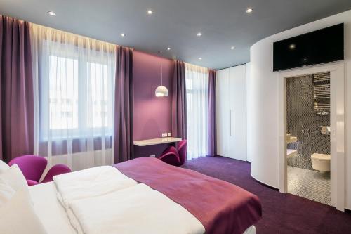 a hotel room with a bed and a bathroom at Pytloun Grand Hotel Imperial in Liberec