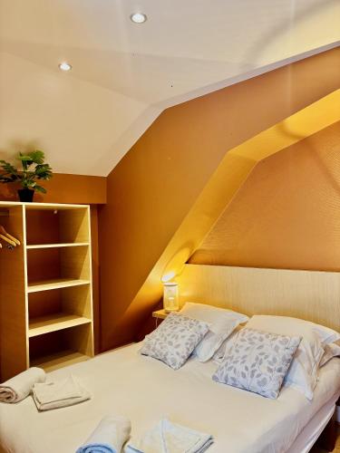 a bedroom with a bed with a wooden wall at La Carpe d'Or in Fontainebleau