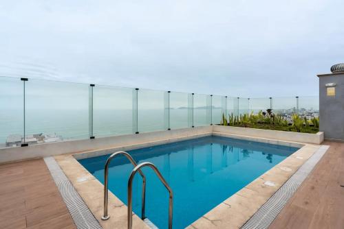 a swimming pool on the roof of a building at Ejército City Lofts & Apartments by Geko in Lima