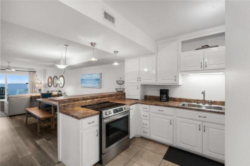 a kitchen with white cabinets and a counter top at Boardwalk Unit E4 in Pensacola Beach