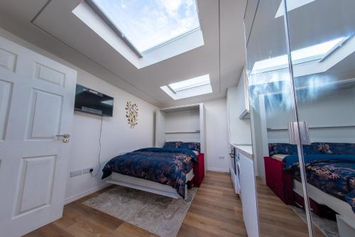 a bedroom with two beds and a door with skylights at Cozy Apartment in Dublin
