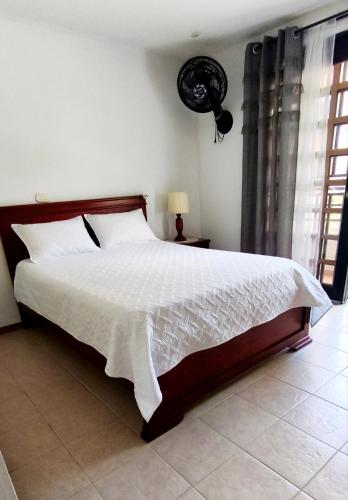 a bedroom with a large bed with a white comforter at Tu Estancia en Cali - Valle del Lili in Cali