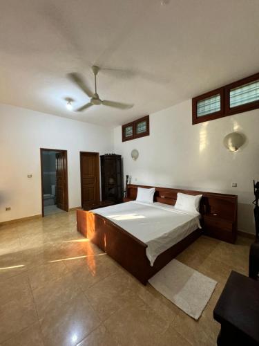 a bedroom with a bed and a ceiling fan at Ramaya Auberge Espagnole in Grand-Popo