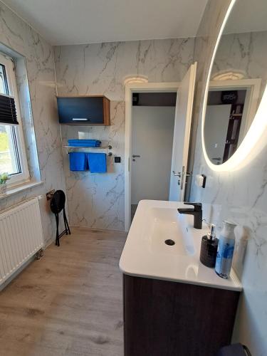 a bathroom with a sink and a mirror at Ferienwohnung Luna in Stralsund