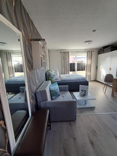 a living room with a couch and a bed at Ferienwohnung Luna in Stralsund