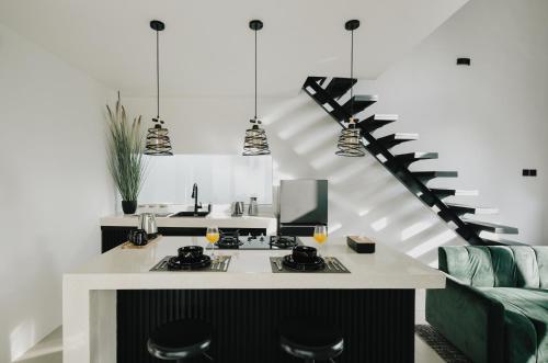 a kitchen with a stove and a living room at Paniora Loft Villas in Kuta Lombok