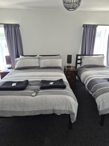a bedroom with two beds with towels on them at The Last Post in Blackpool