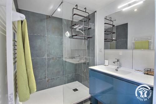 a bathroom with a sink and a glass shower at ô nid des grèves in Langueux