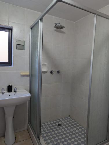 a bathroom with a shower and a sink at Carravensiria Chalet 27 in Hibberdene