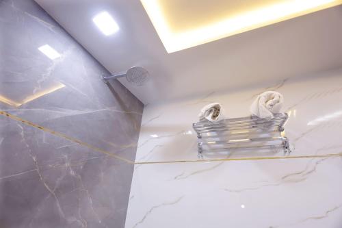 a bathroom with a towel rack on the wall at Hotel Golden Palace in Agra