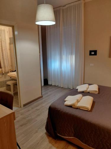 a bedroom with a bed with two towels on it at Piazza del Popolo Suites in Rome