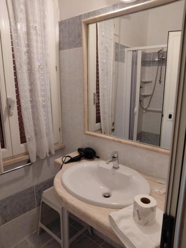 a bathroom with a sink and a mirror at Piazza del Popolo Suites in Rome
