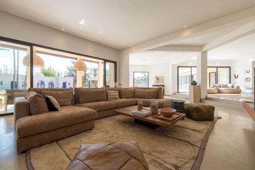 a large living room with a couch and a table at Villa Yliane in Marrakesh