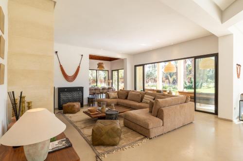 a living room with a couch and a fireplace at Villa Yliane in Marrakesh