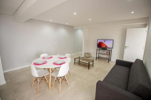 a living room with a table and a couch at Guest H4U Povoa Vacation City center in Póvoa de Varzim