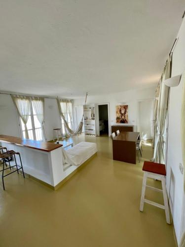 a living room with a bed and a table at Surf House Casa Vehla in Sal Rei