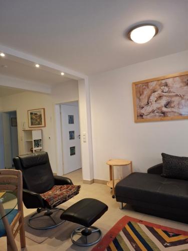 a living room with a couch and two chairs at Appartement am Goldsteinpark in Bad Nauheim