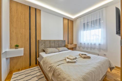 a bedroom with a bed with two phones on it at Vip Bogic 108 in Zlatibor