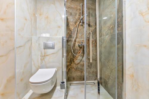 a bathroom with a toilet and a shower at Vip Bogic 108 in Zlatibor