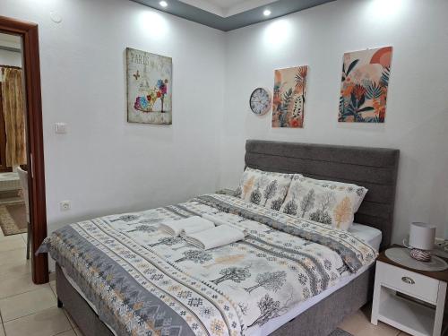 a bedroom with a bed with a blanket on it at Paradise Bridge in Xanthi