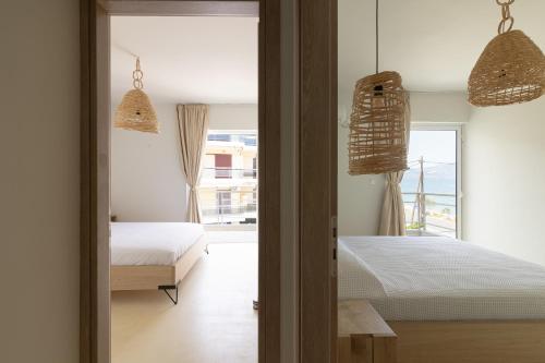 a bedroom with two beds and a window at Euphoria Mare in Néa Palátia