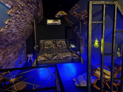 a bedroom with a bed in a room with blue lights at Taelia spa in Rosult