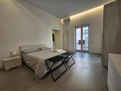 a bedroom with a bed and a table in it at Casa Bon in Marigliano