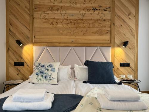 a bedroom with a bed with two pillows on it at GreenHill Bachleda in Zakopane