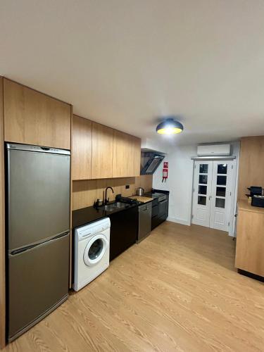 a kitchen with a washer and dryer in it at Aquae Flaviae Urban Stay - Duplex in Chaves