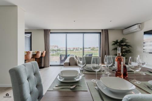 a dining room with a table with wine glasses at Shore Apartments - Santa Cruz in Santa Cruz