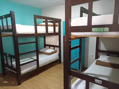 a room with three bunk beds in a room at Mango Hostel B&B in Arequipa