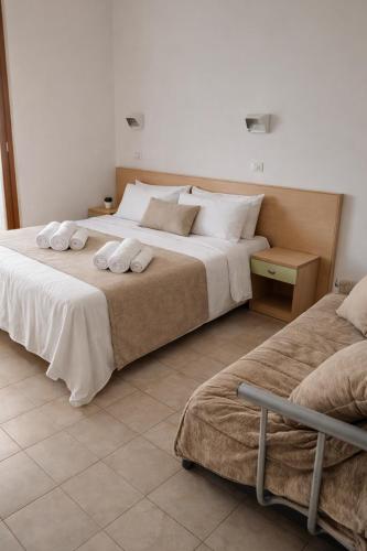 a bedroom with two beds with towels on them at Residence Hotel Claudia in Alba Adriatica