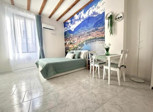a bedroom with a bed and a table with a tableablish at Lecco's heart! Centro Lecco - A due passi dal lago - Moderno e luminoso in Lecco