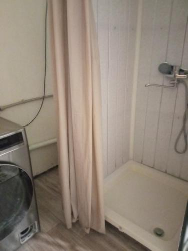 a shower with a shower curtain in a bathroom at room with a mountain view in Zugdidi