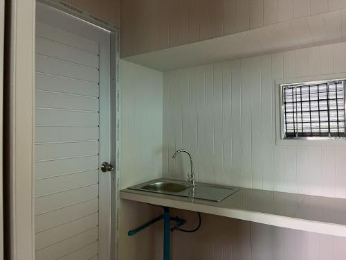 a kitchen with a sink and a window at Wildnest House in Ko Yao Noi