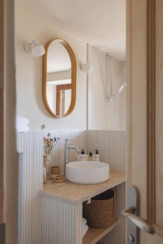 a bathroom with a sink and a mirror at Les Terrasses de la Borie in Mandagout