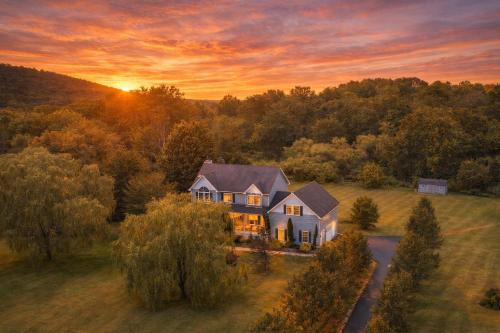 an aerial view of a house with a sunset at Malkita Aria Mountainview Retreat in Woodbury