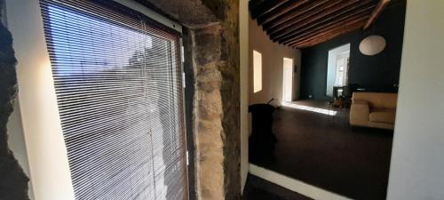 a room with a large window with blinds at Casa Branca AL in Monchique