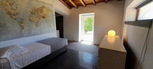 a bedroom with a bed with a map on the wall at Casa Branca AL in Monchique