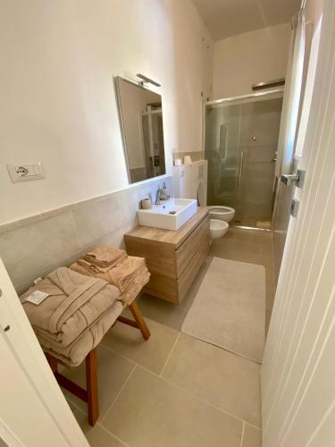 a bathroom with a sink and a toilet and a mirror at Stella di Mare with Jacuzzi, Costa Smeralda in Arzachena