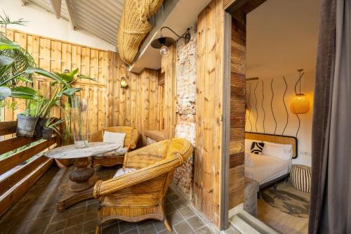 a room with wooden walls and a table and chairs at Abalú Collection Hotel Life Gran Via in Madrid