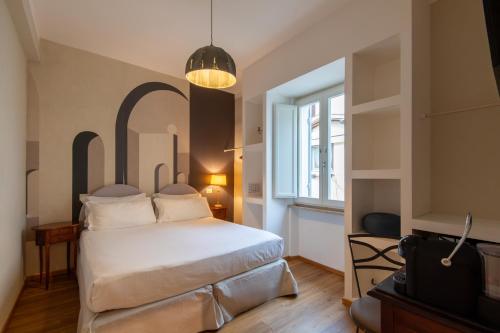 a bedroom with a white bed and a window at Aurora Boutique Hotel & Private SPA - Etruria Collection in Spoleto